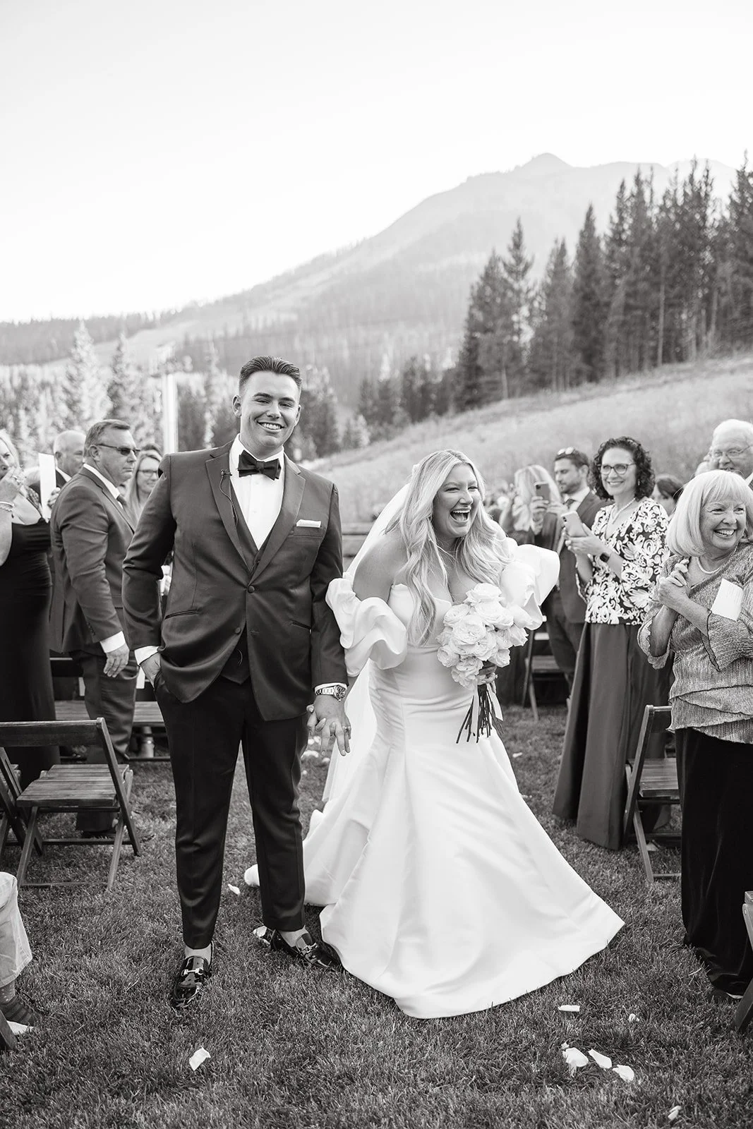 bride and groom getting married in big sky Montana walking down the aisle in the summer