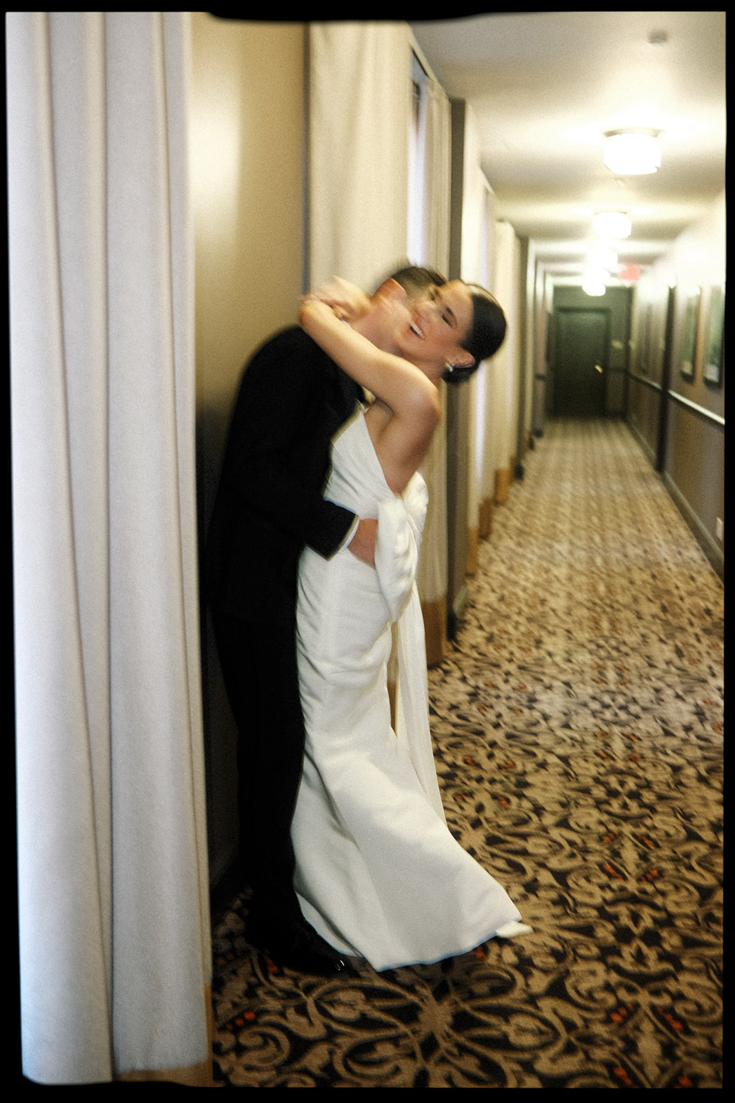Stunning film photo of bride and groom hugging after ceremony at the Mayo Hotel by Laura Powers Photo
