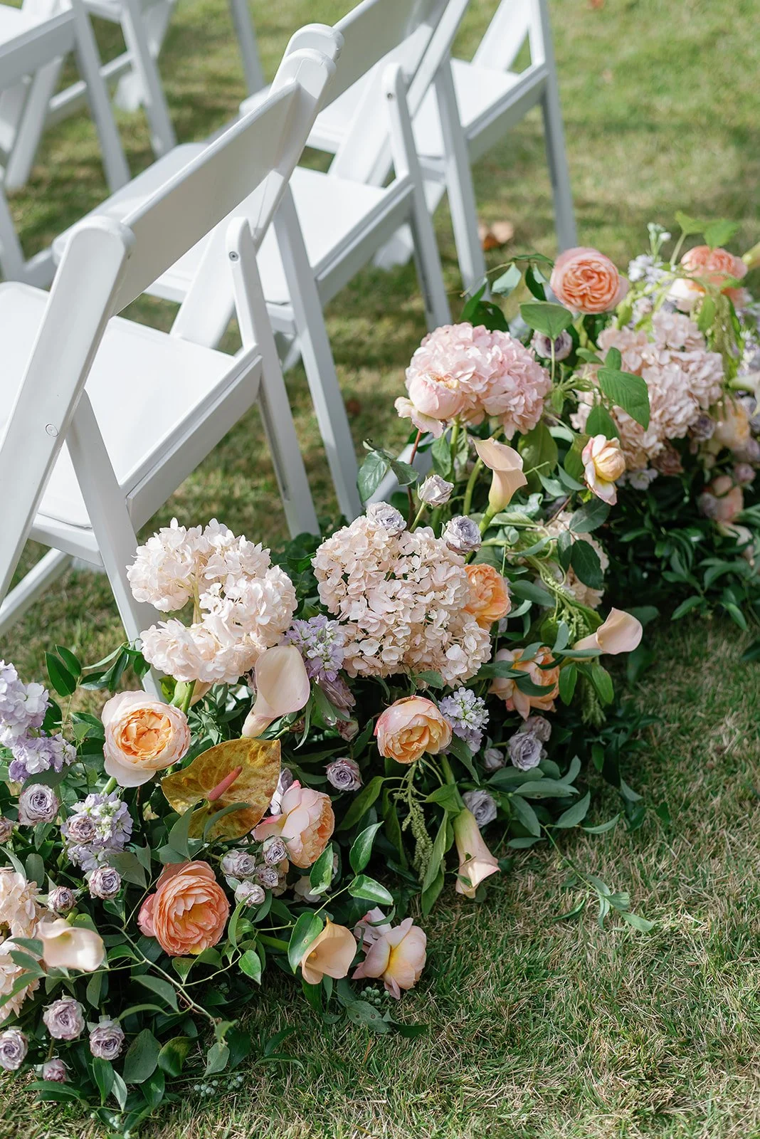 Film photos of colorful spring pastel florals at wedding ceremony by Laura Powers Photo