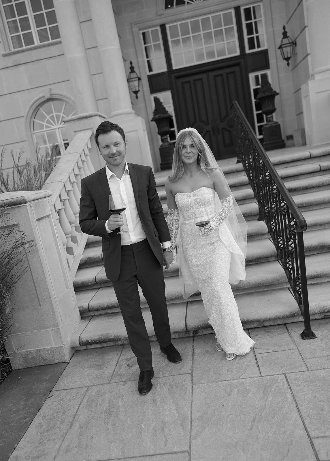 Photo of Bride and groom holding wine after their ceremony at beautiful luxury home by Laura Powers Photo