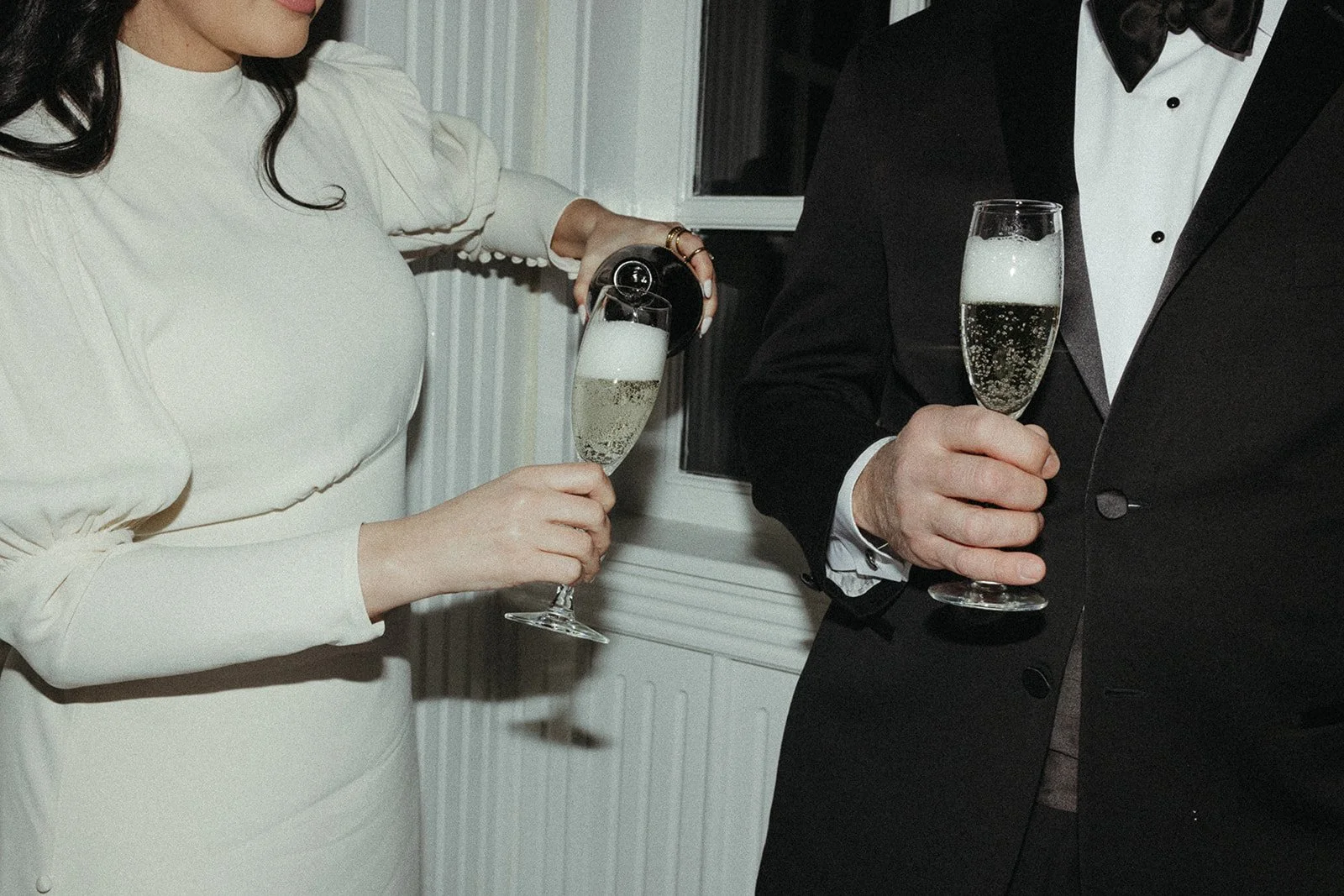 Film photos of bride and groom pouring champagne at their wedding reception in Eureka Springs, Arkansas by Laura Powers Photo
