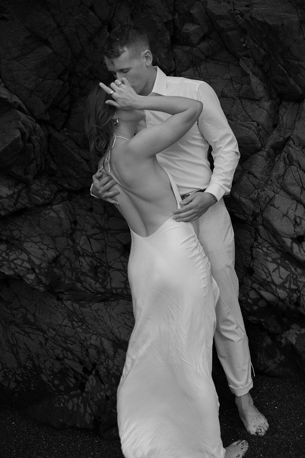 couple walking on the Rodeo Beach in San Francisco, California taking engagement photos with flowy dress, by Laura Powers Photo