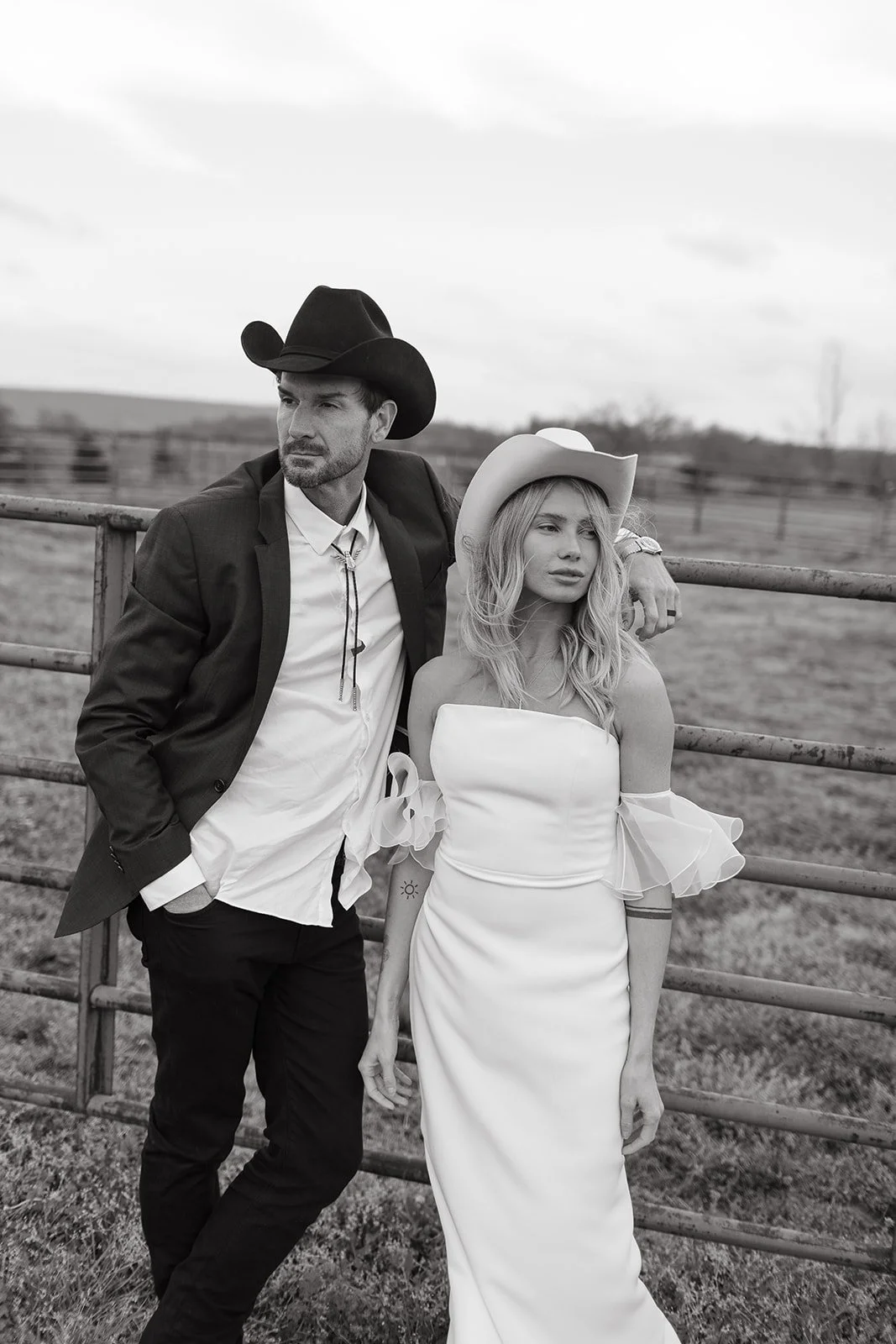 Editorial Chic Western photo of bride and groom with cowboy hats on